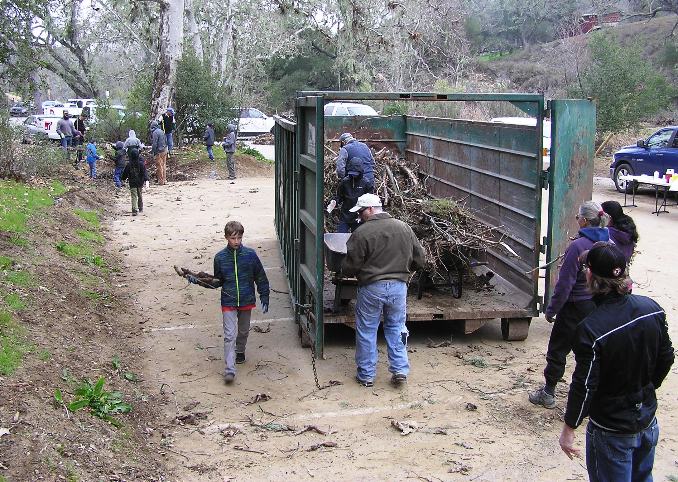 Packing the debris into the dumpster.